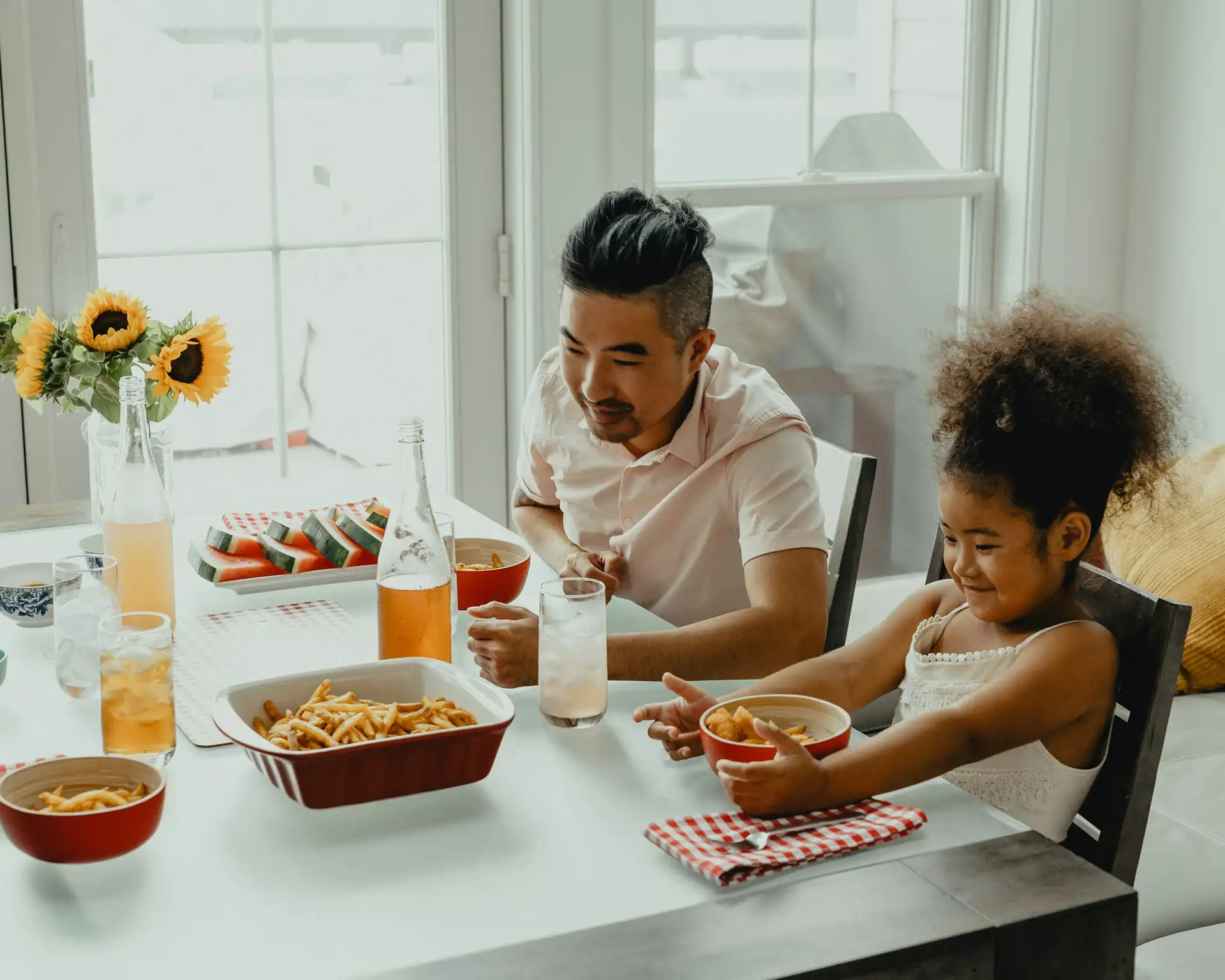 Family meal around a large table in a holiday house
