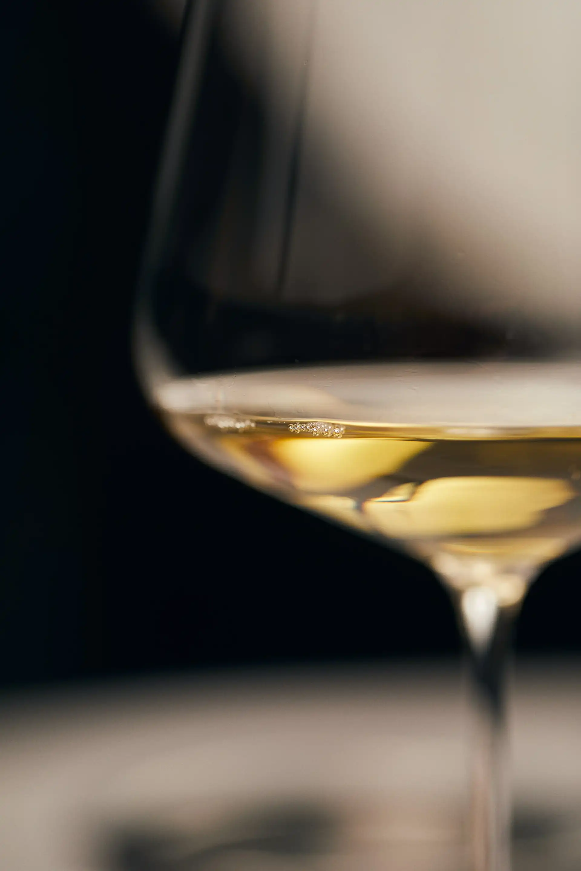 Glass of white Chablis ready for tasting